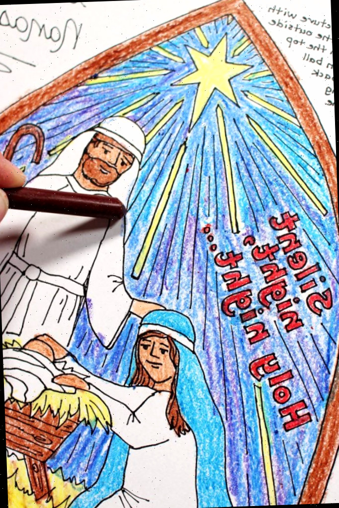 Um lápis de cera marrom colorindo José na cena do presépio.