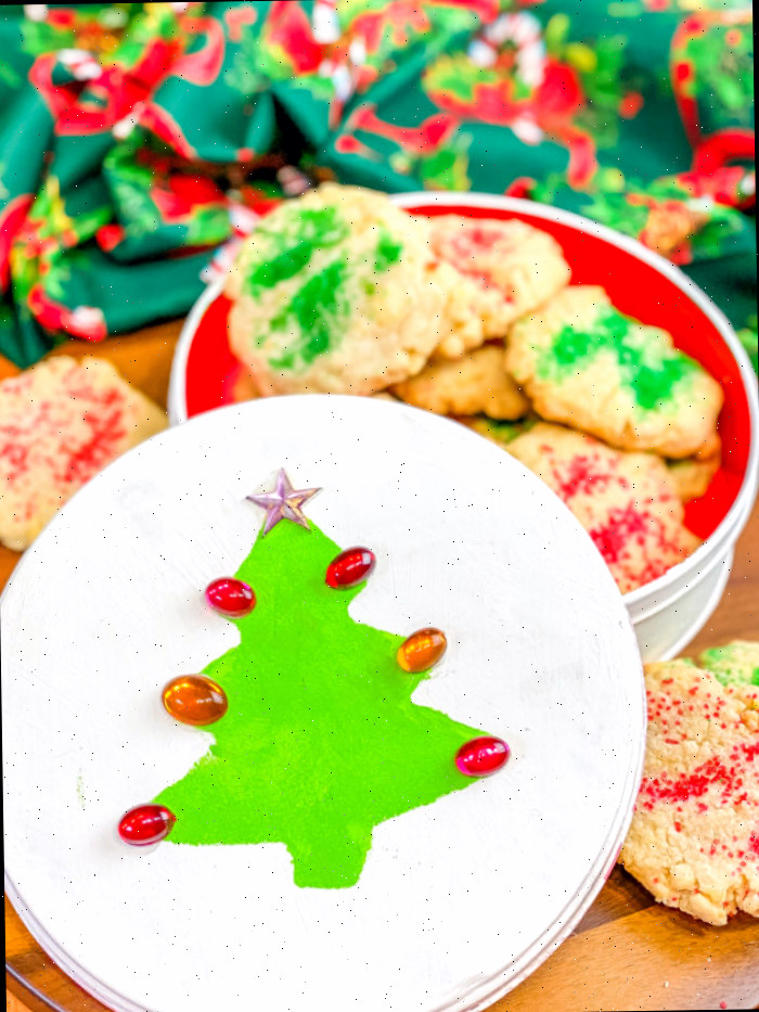 Árvore natalina verde com pedras vermelhas em lata branca de Natal cheia de biscoitos de açúcar