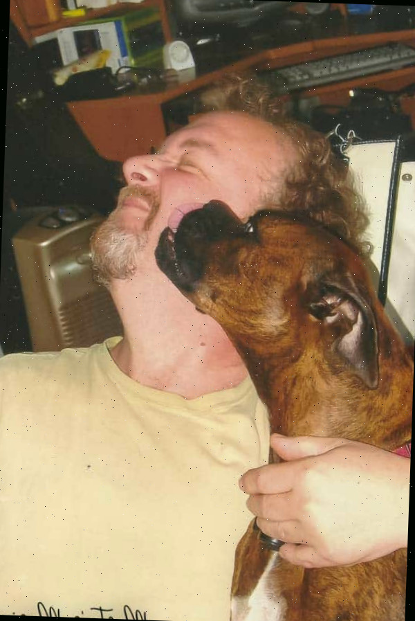 Um homem acariciando um animal