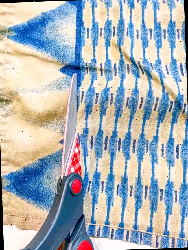 use a tesoura para cortar uma toalha vintage azul e marrom