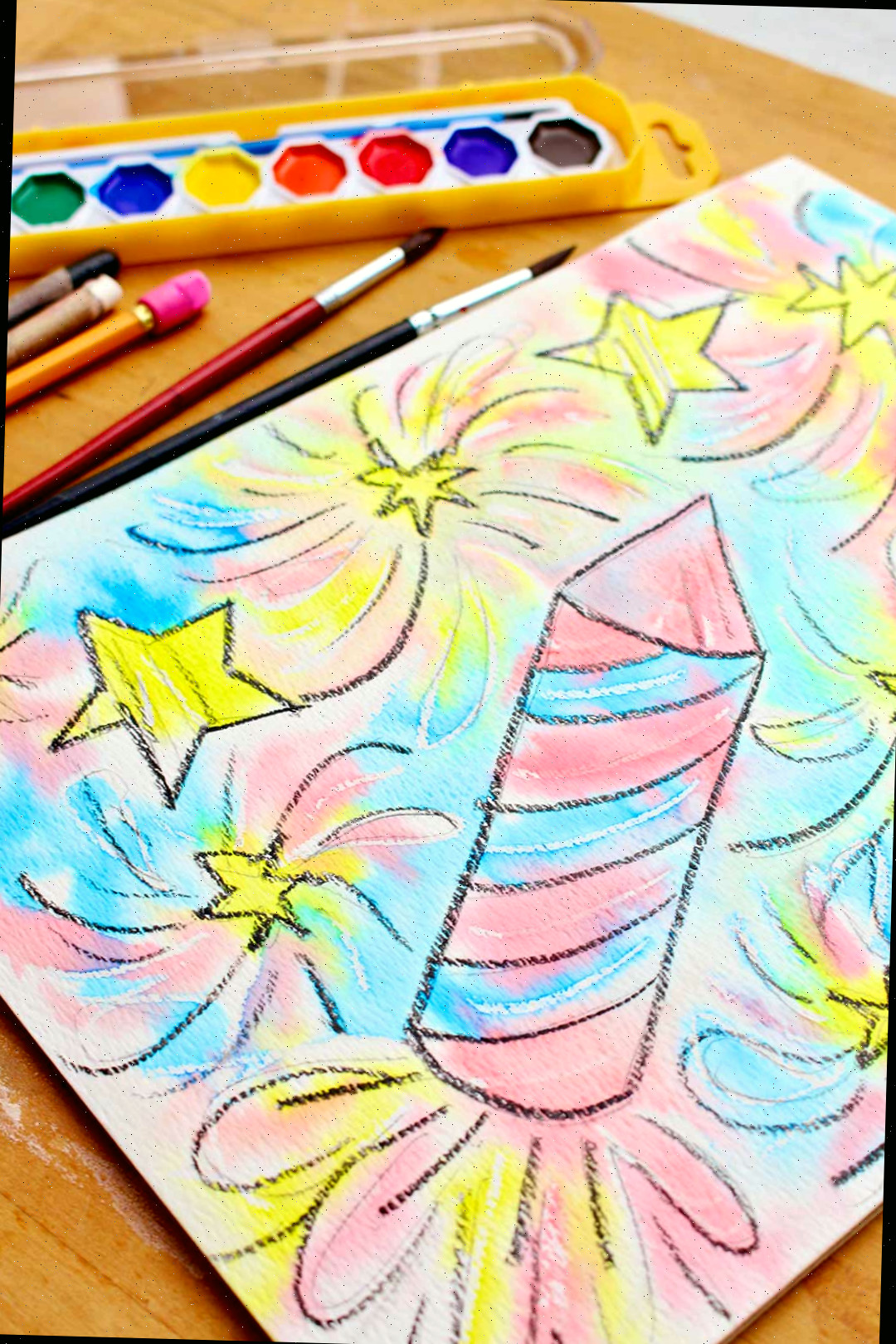 Visão de perto da resistência em aquarela concluída com aquarelas, pincéis e lápis à direita.