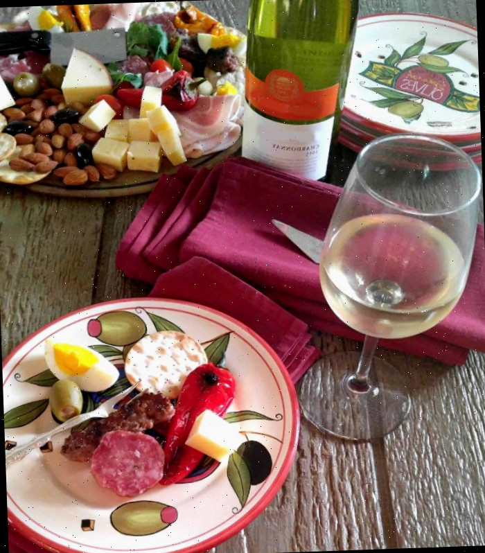 Antipasto apresentado em pratos especiais de aperitivo com vinho
