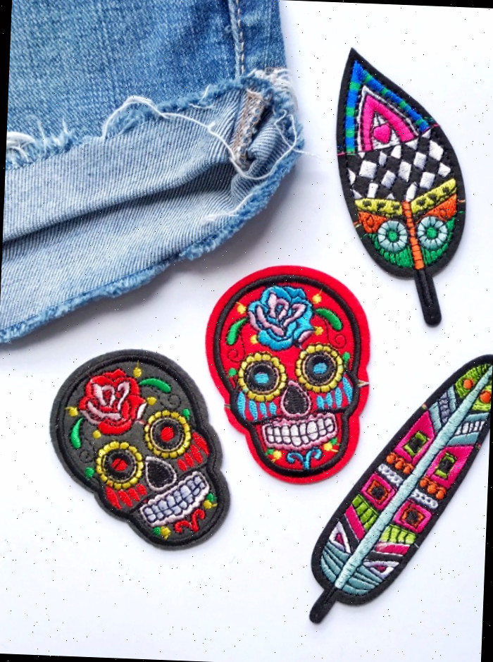 Padrões de ponto cruz de Halloween - Patches bordados ao lado de um par de shorts jeans