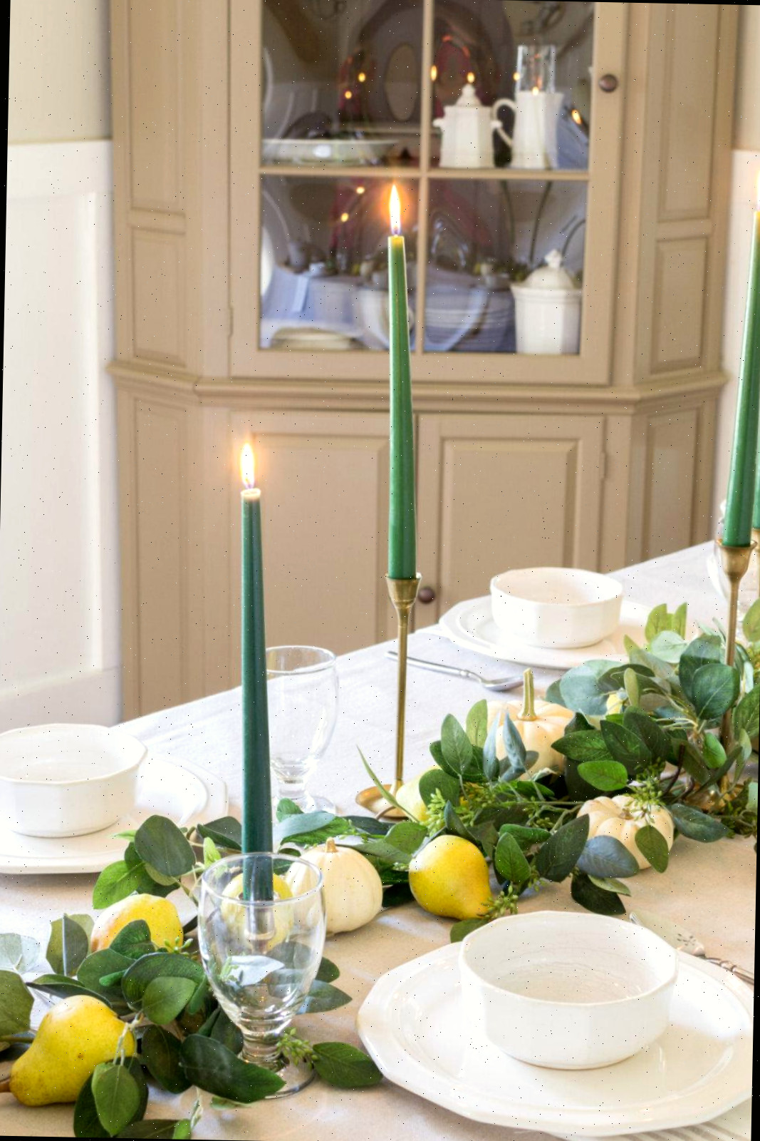 Candelabros de latão com velas verdes fornecem altura à minha mesa de outono
